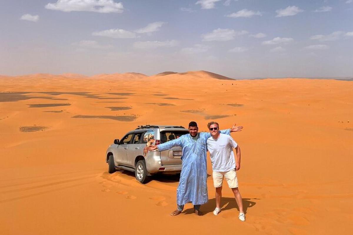 two men standing in the desert with a car