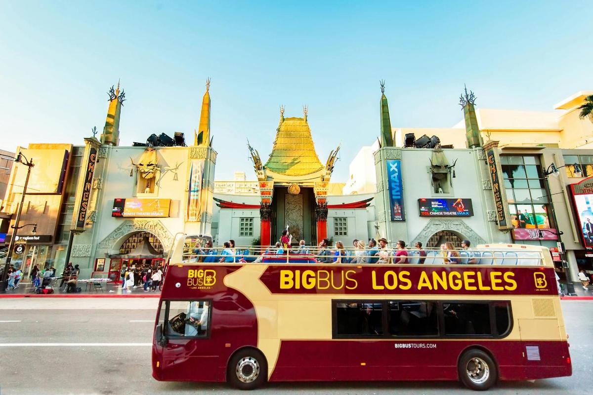 a bus in front of a building with people