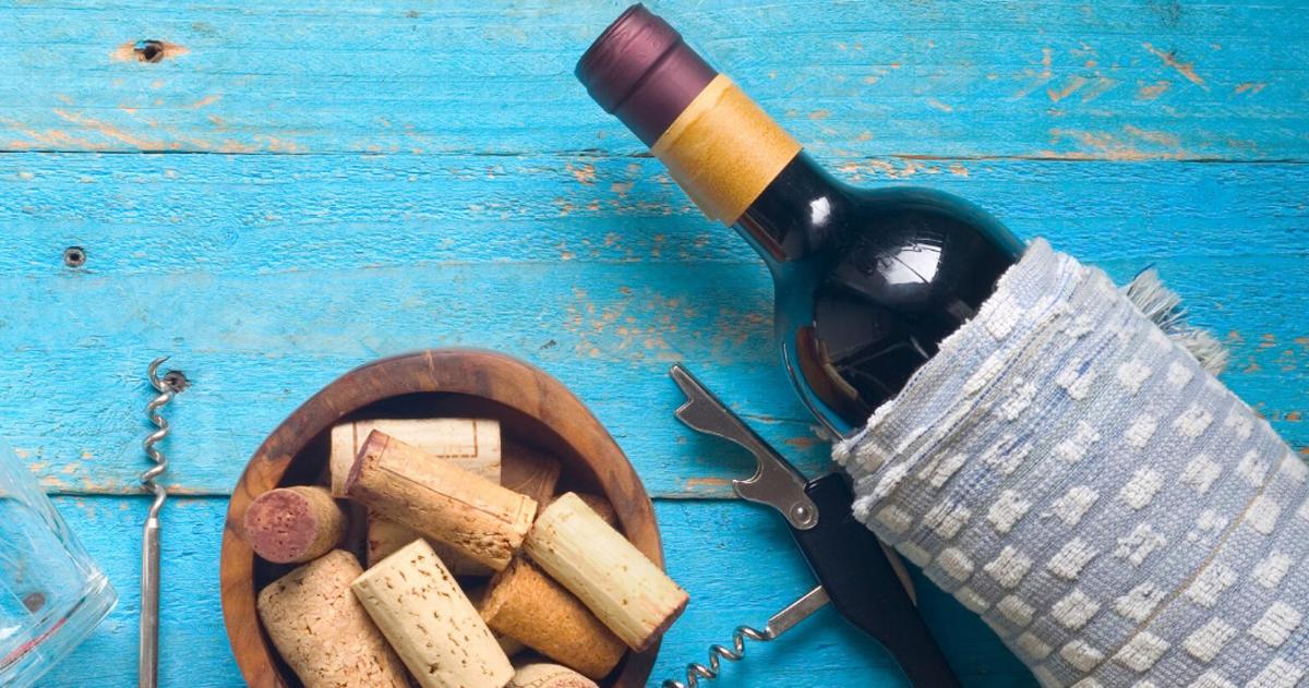 a bottle of wine and a bowl of wine corks