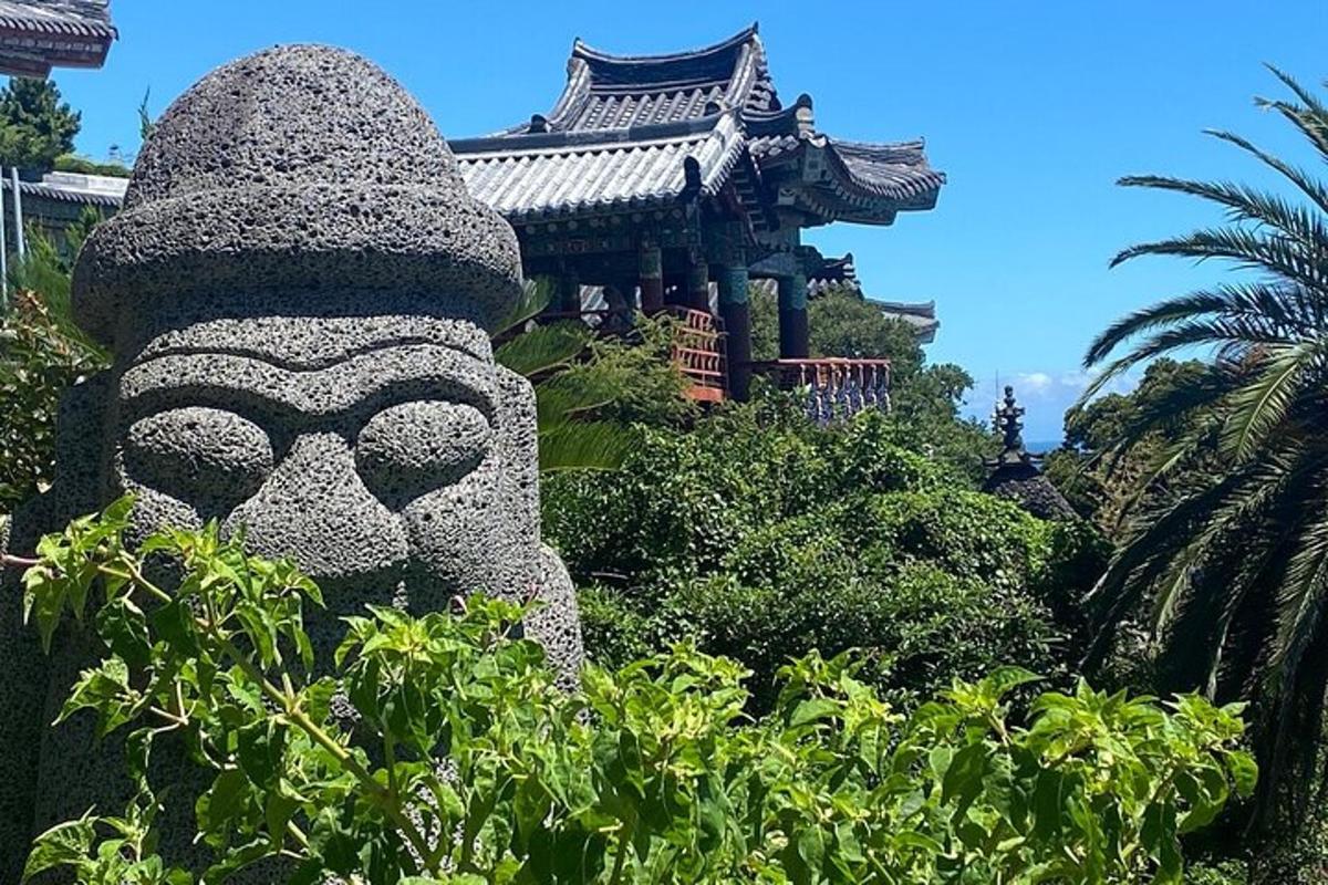 a statue of a mask in front of a building