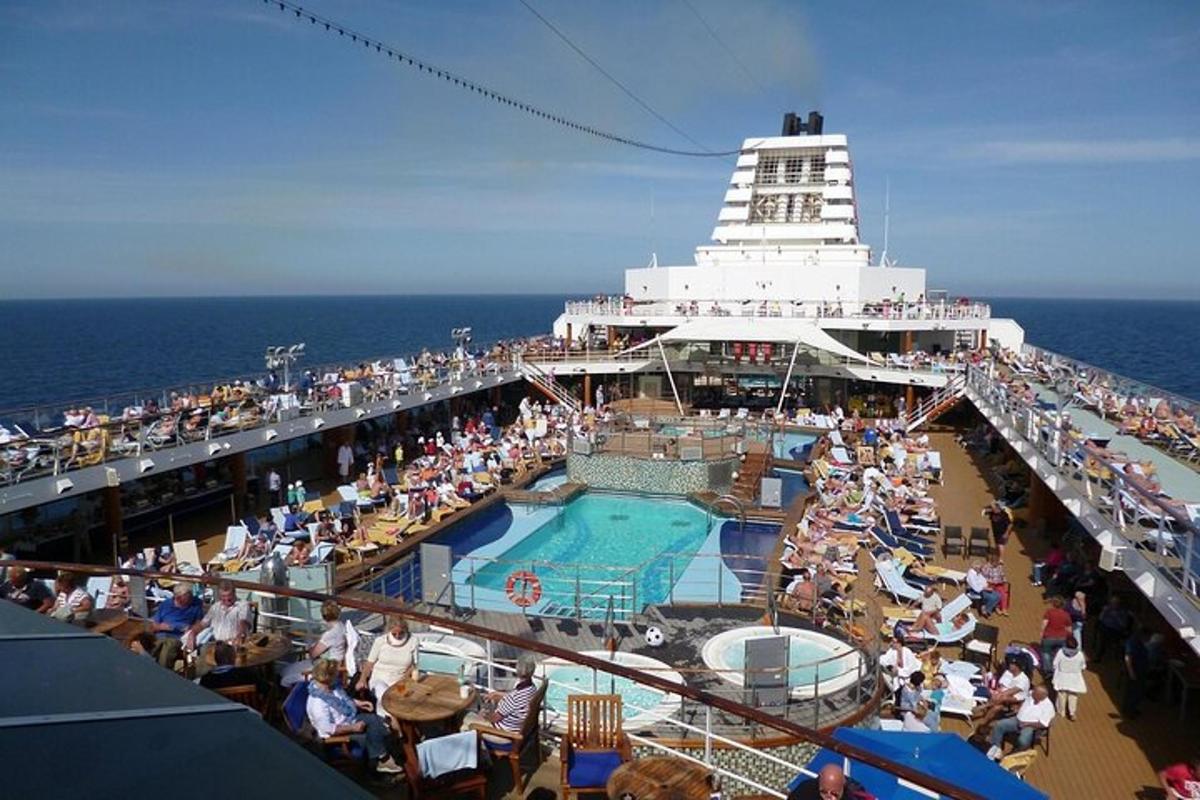 a group of people sitting on the deck of a cruise ship