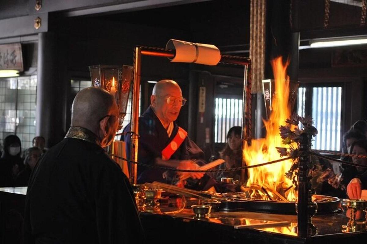 a man cooking food in front of a fire