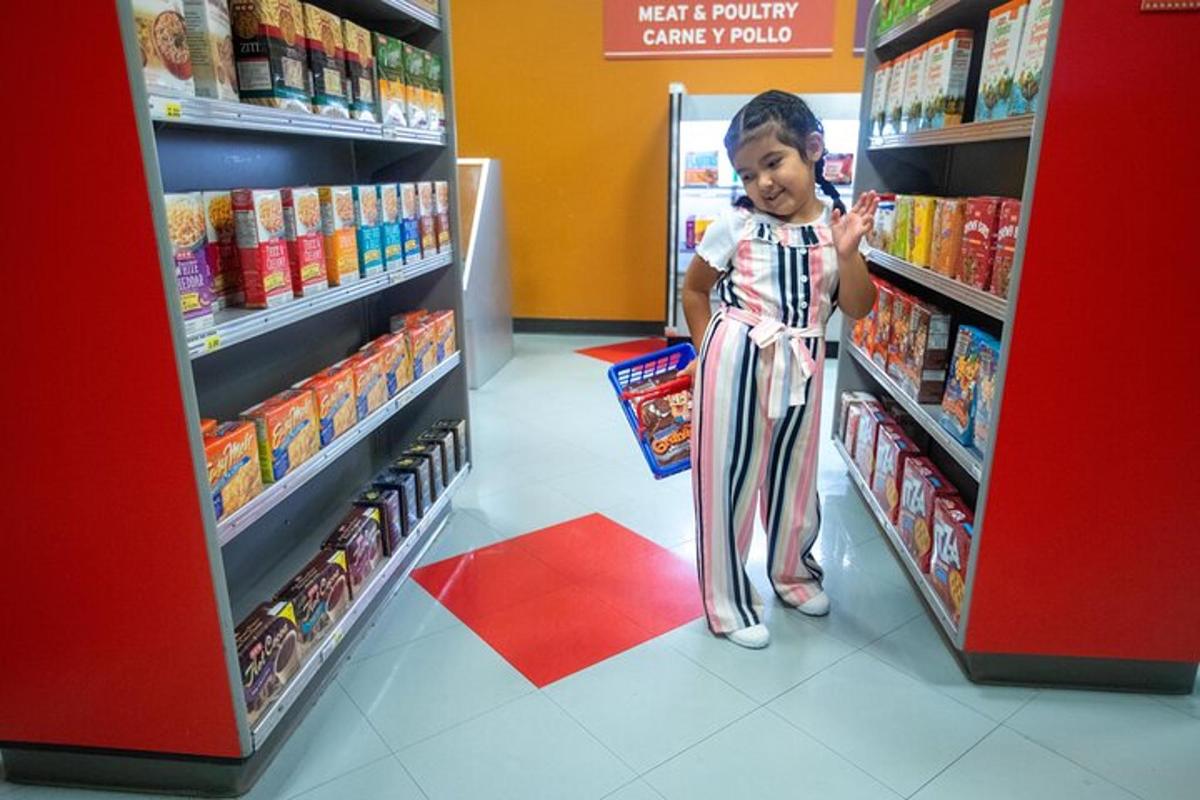 a young child is standing in a store aisle