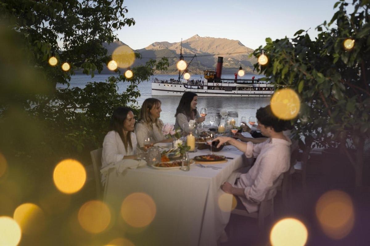 a group of people sitting at a table eating