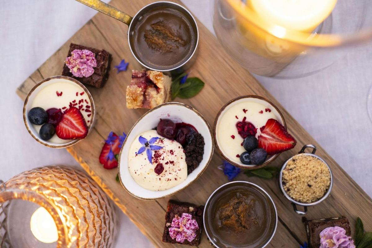 a tray of food with desserts on a table
