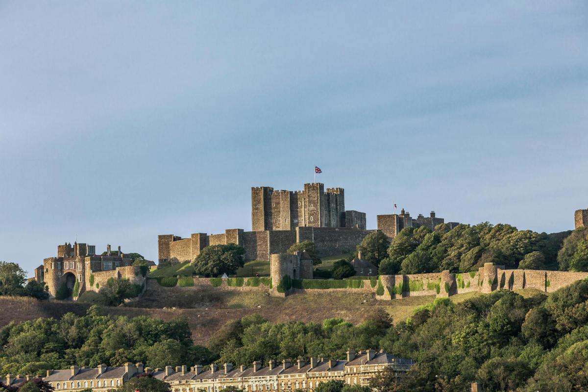a castle on top of a hill with houses