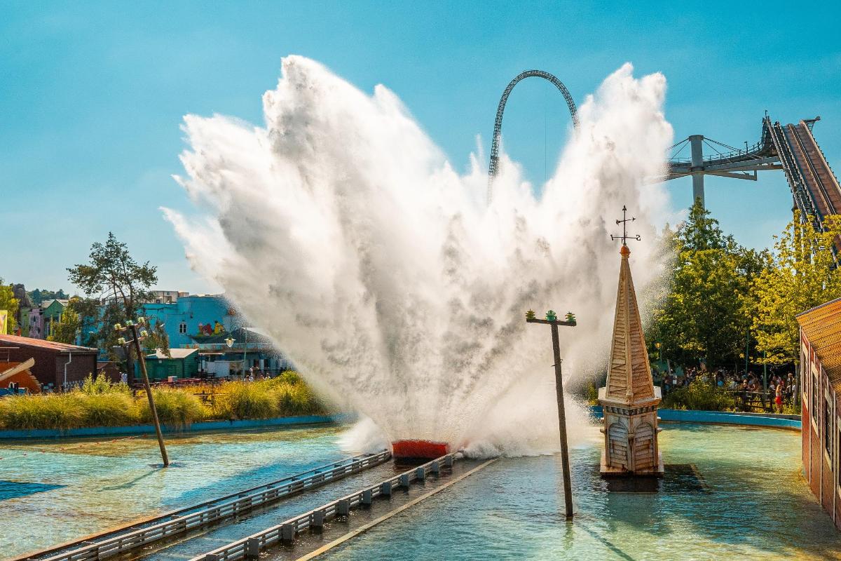 a large fountain in the water at an amusement park