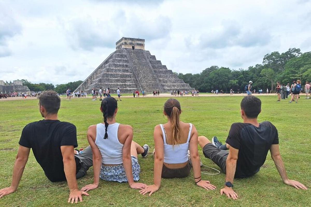 a group of people sitting in front of a pyramid
