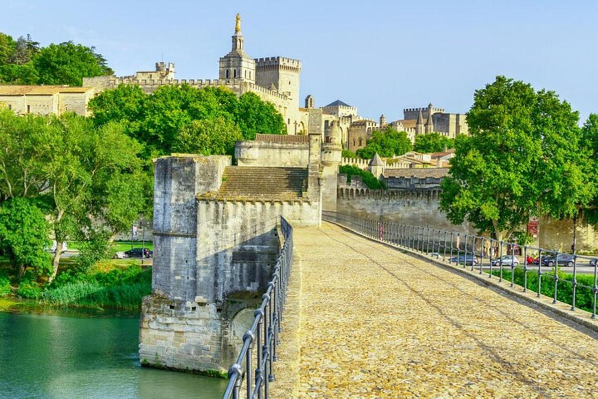 a bridge over a river with a castle in the background
