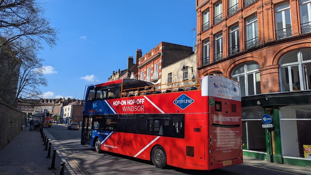 a red double decker bus parked on a city street