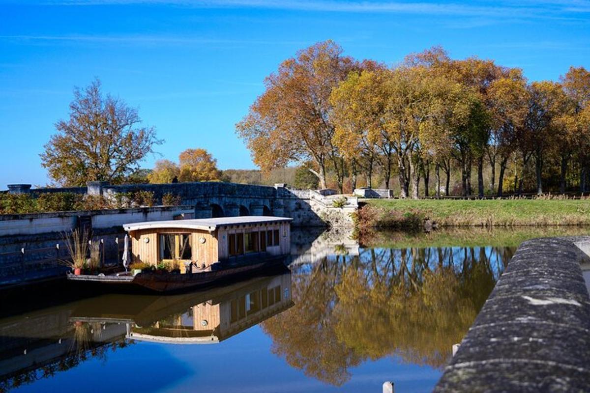 a boat is docked in a river with trees
