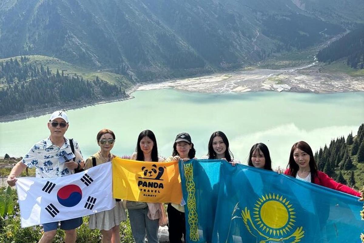 a group of people holding flags on top of a mountain