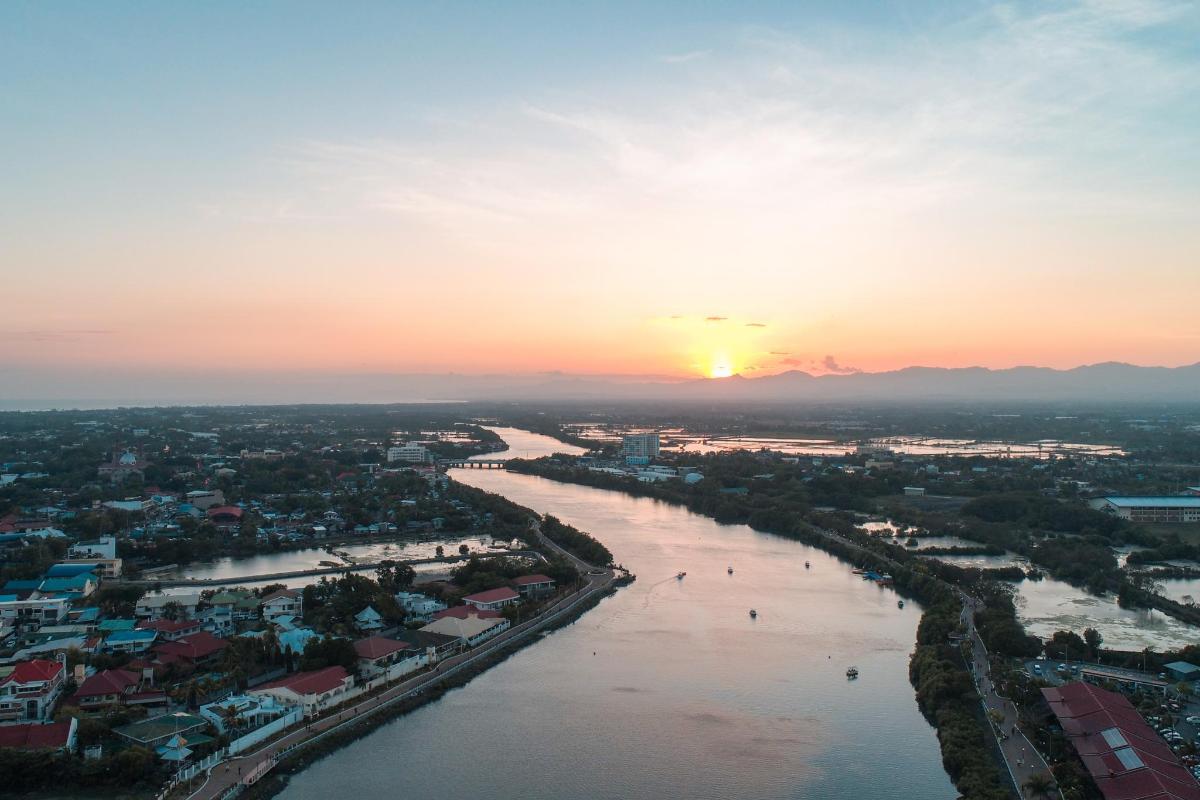 an aerial view of a river at sunset