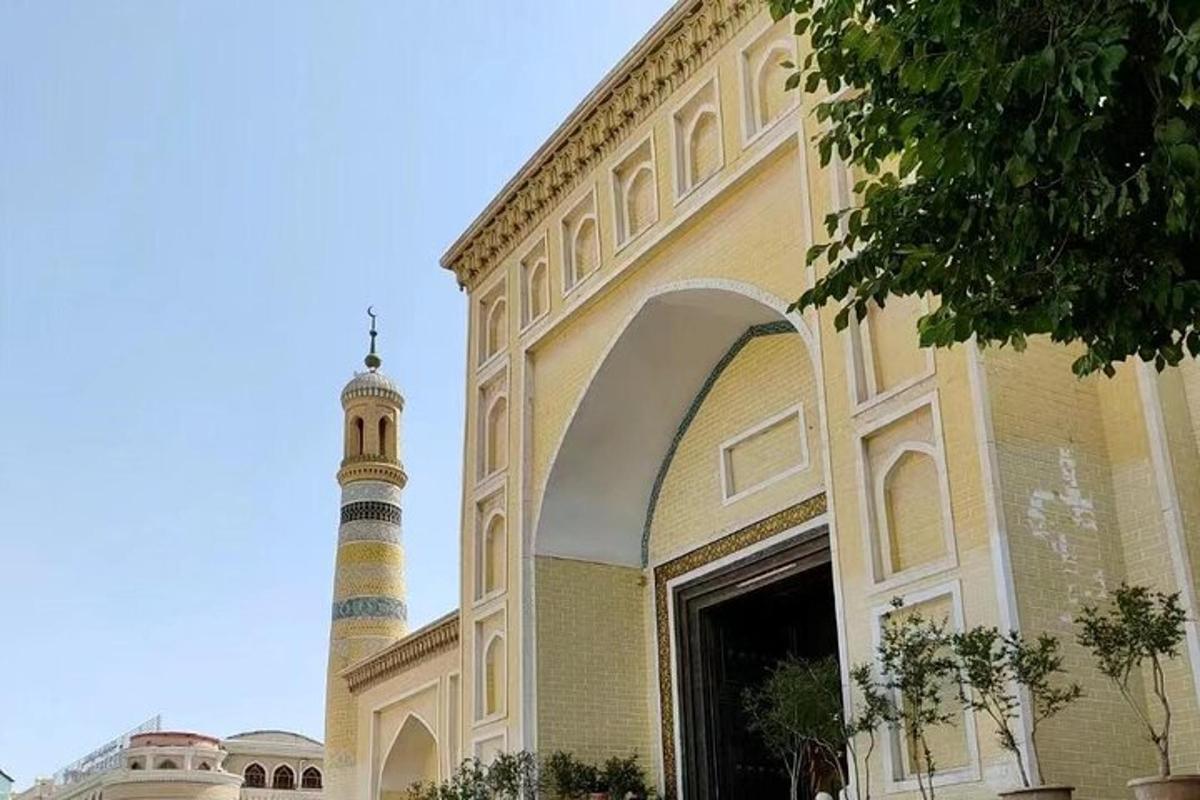 a building with a mosque with a clock tower