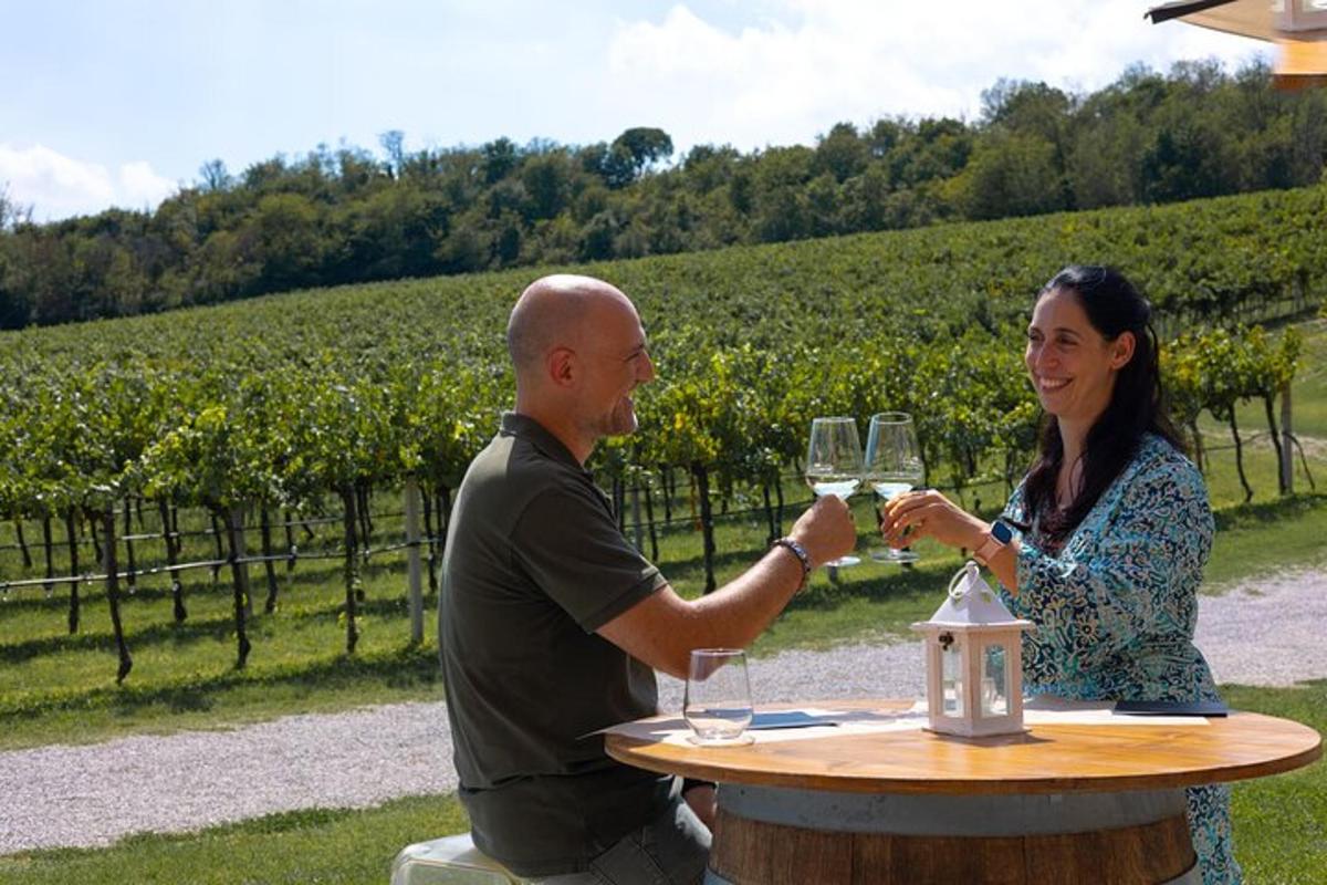 a man and a woman sitting at a table with wine glasses