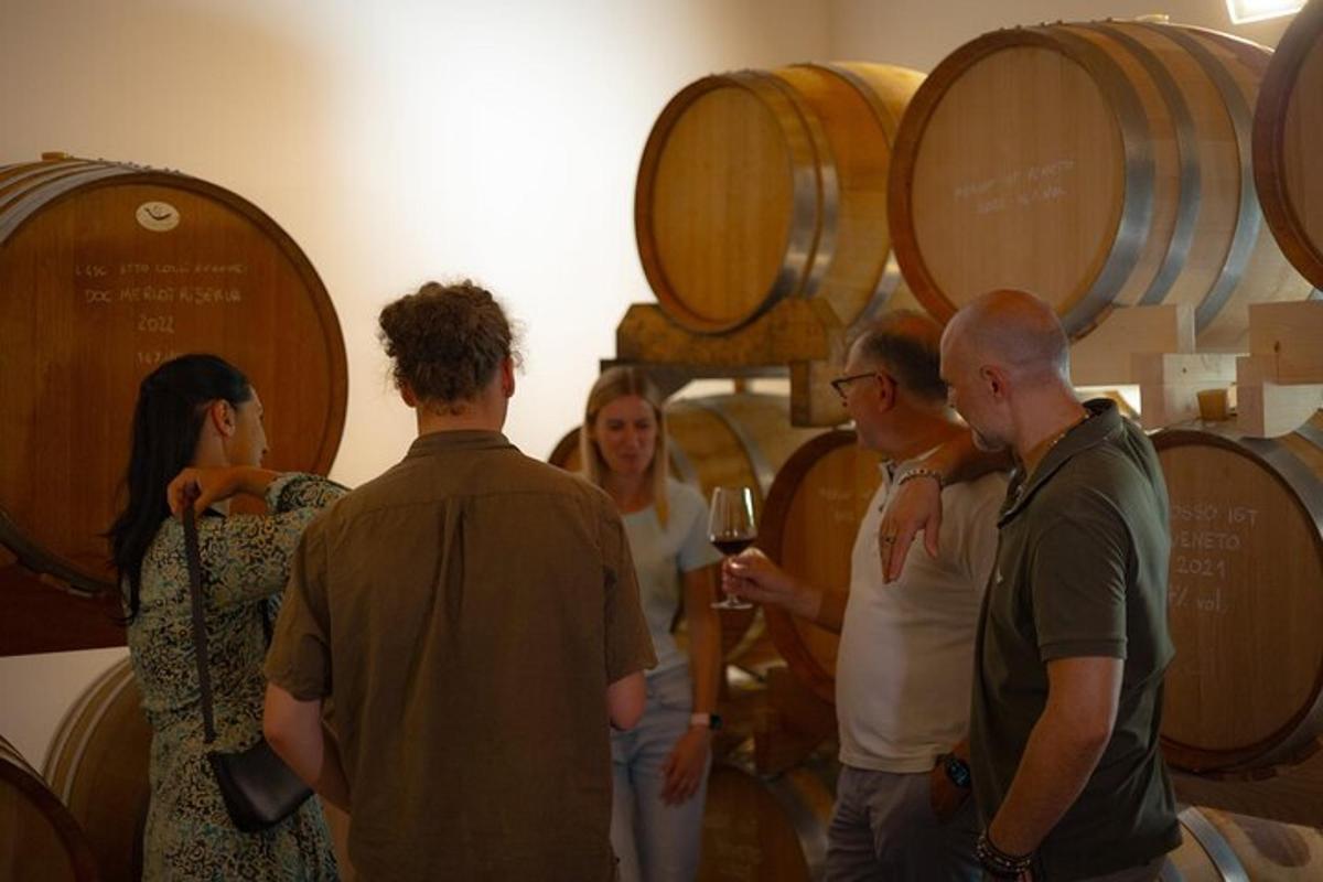 a group of people standing in a wine cellar