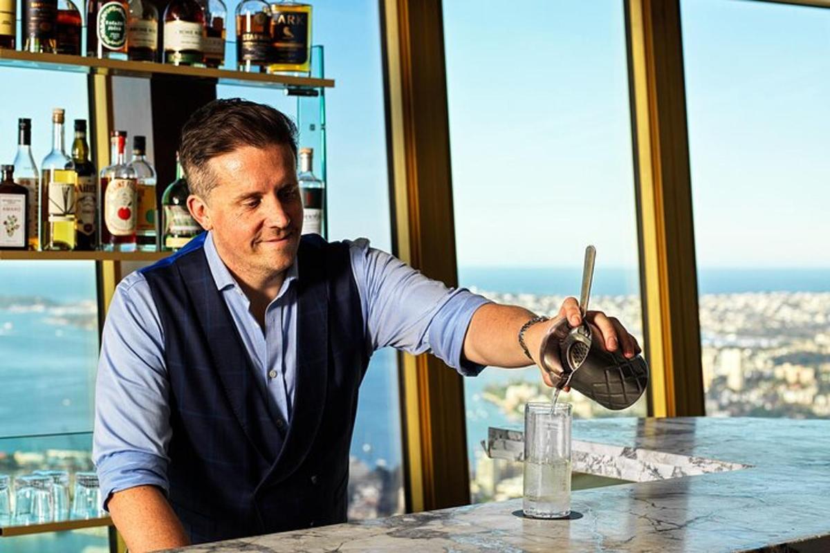 a man sitting at a bar with a drink