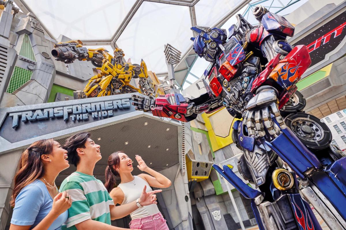 a group of people looking at a transformers robot