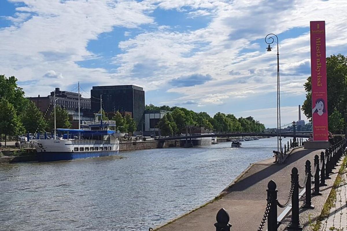 a boat is docked on a river in a city