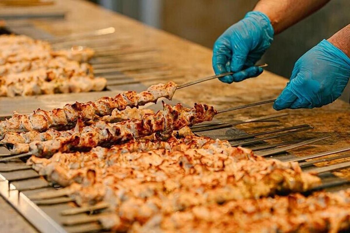 a person is cooking food on a grill