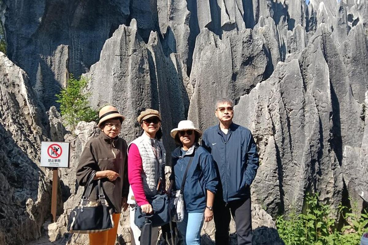 a group of people standing in front of a mountain
