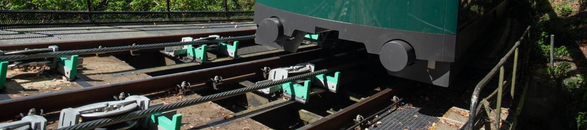an overhead view of train tracks with a green train