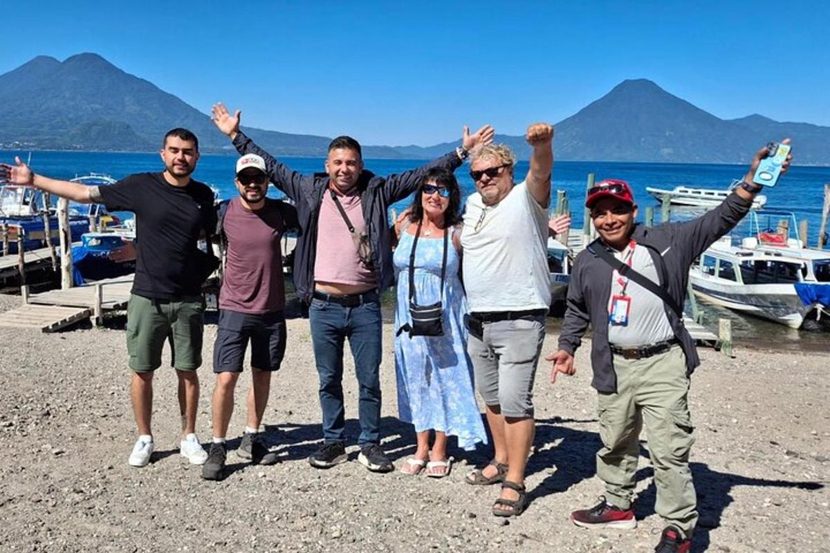 a group of people standing on a beach with their hands up