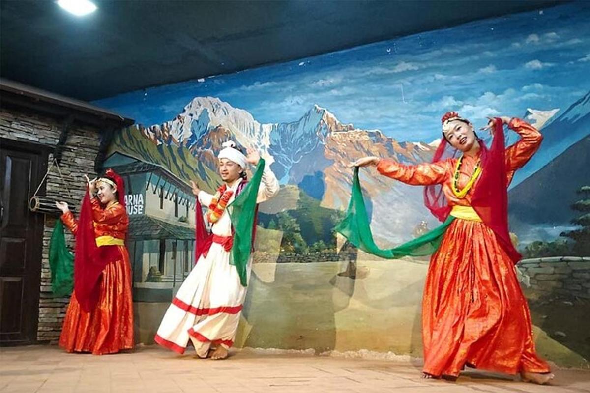 a group of women dancing in front of a mural