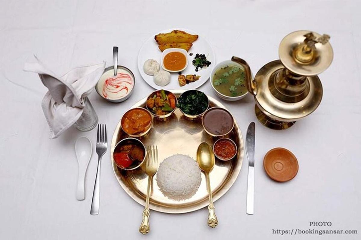 a white table with a plate of food and utensils
