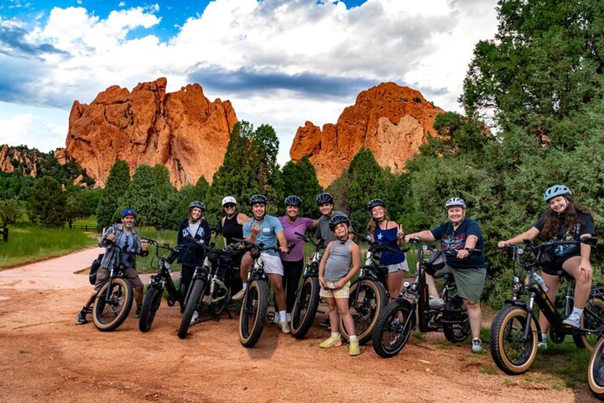 a group of people posing for a picture in front of rocks