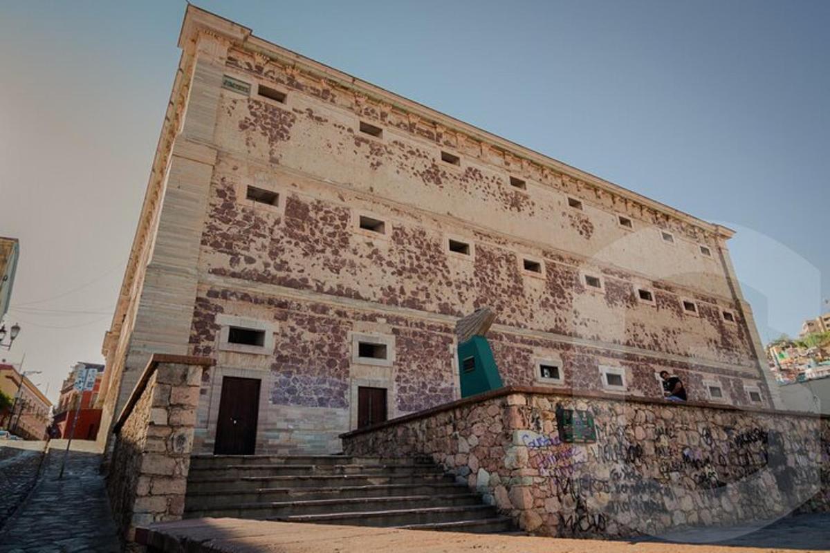 an old building with graffiti on the side of it