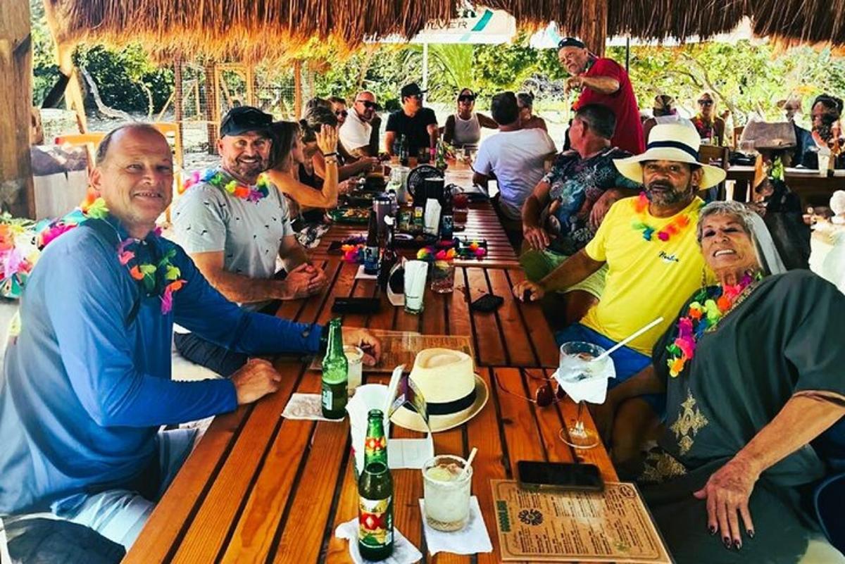 a group of people sitting around a long wooden table