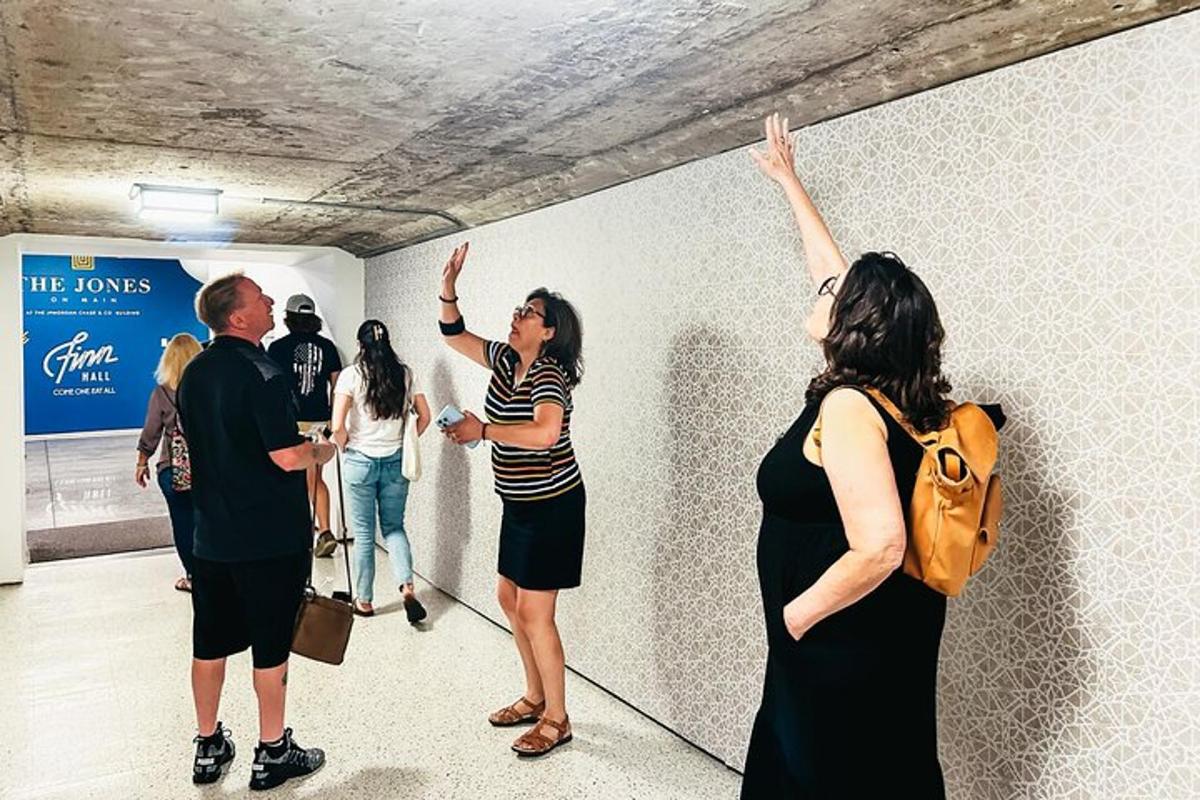 a group of people standing around a wall with their hands in the air