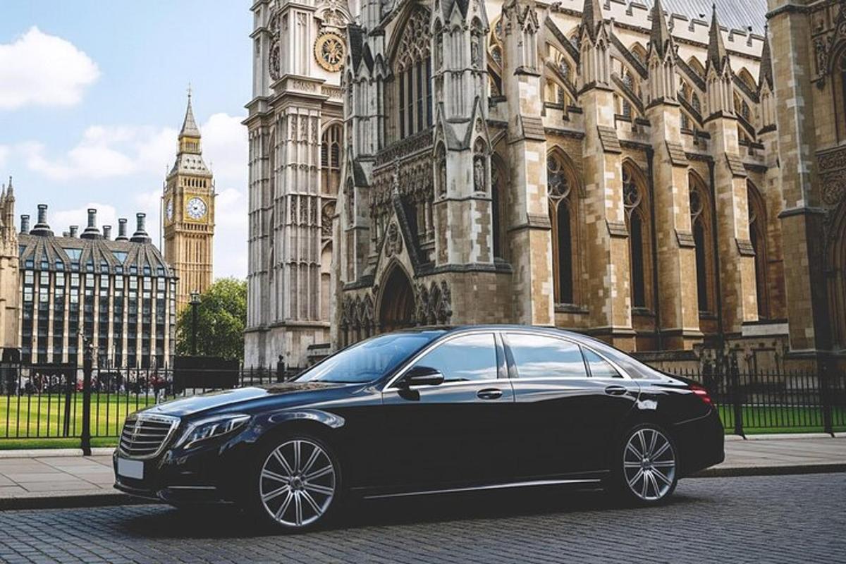 a black car parked in front of a large building