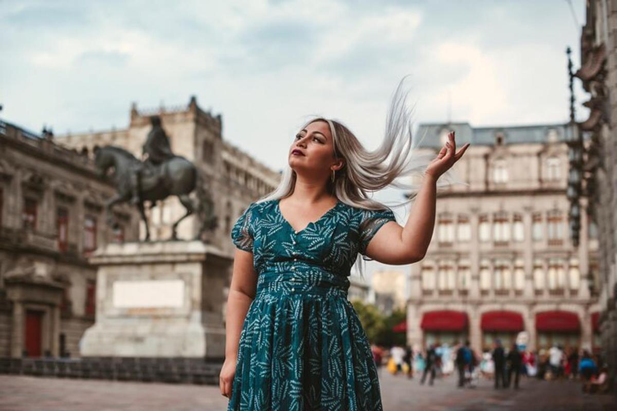 a woman in a green dress standing in a city