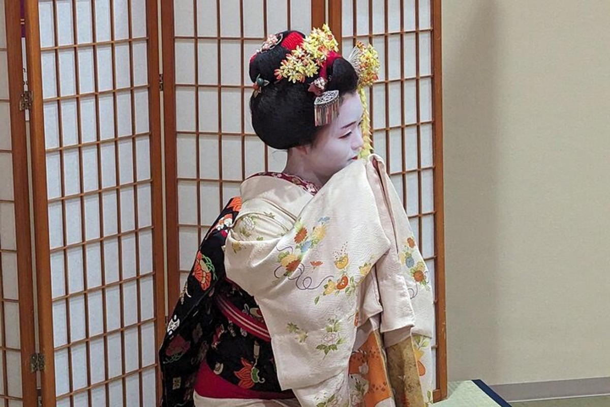 a woman in a kimono standing next to a cage