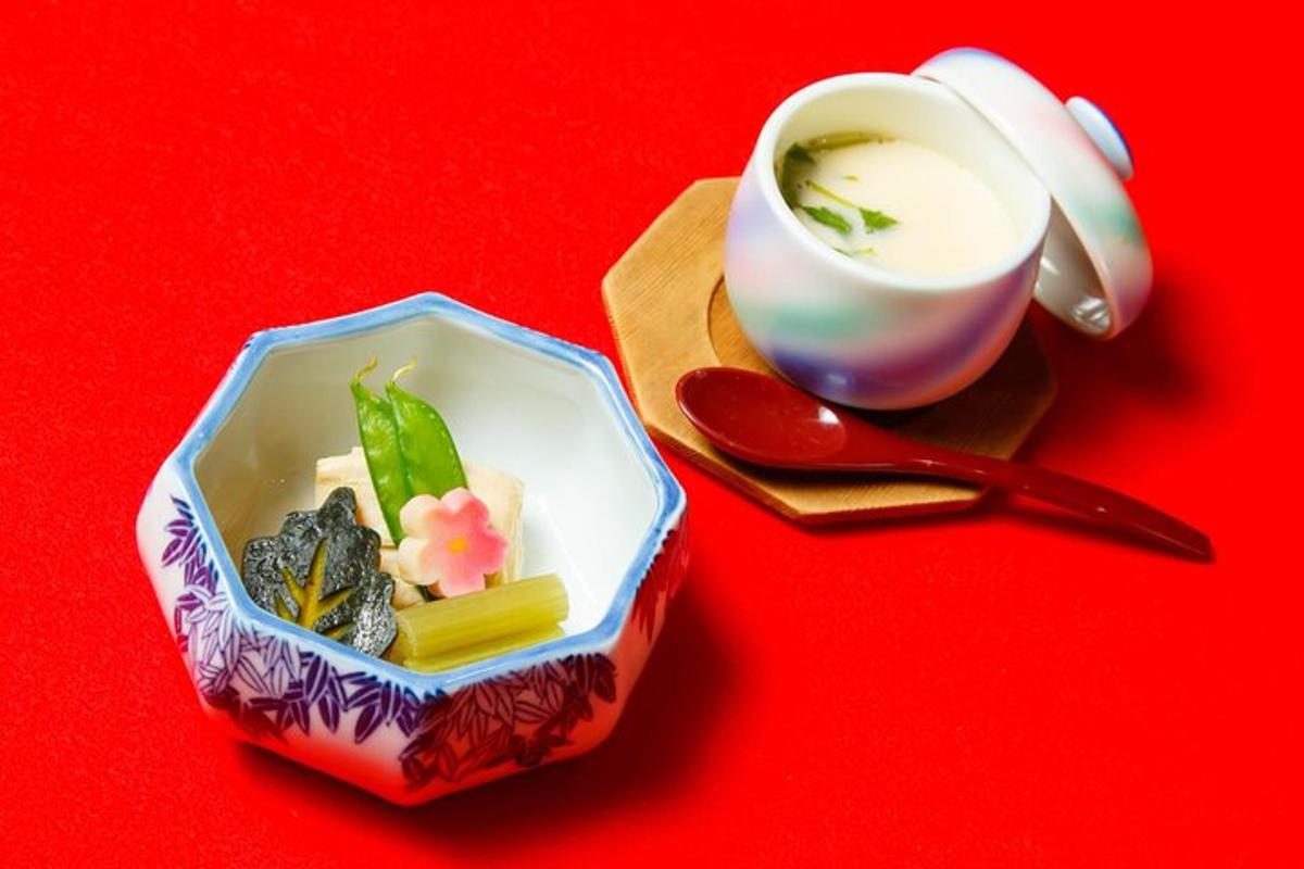 a cup of tea and a small box of food