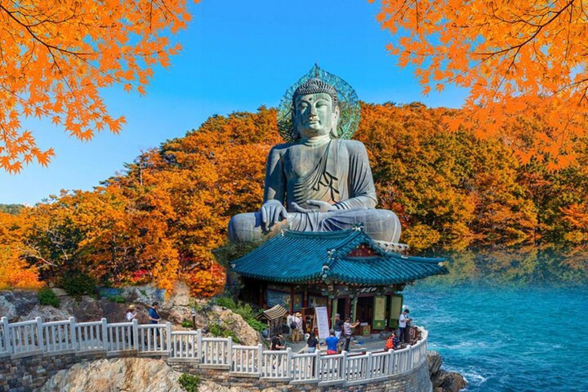 a large buddha statue sitting in the water