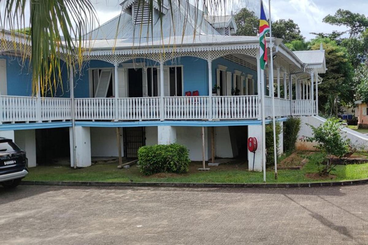 a blue and white house with a white balcony