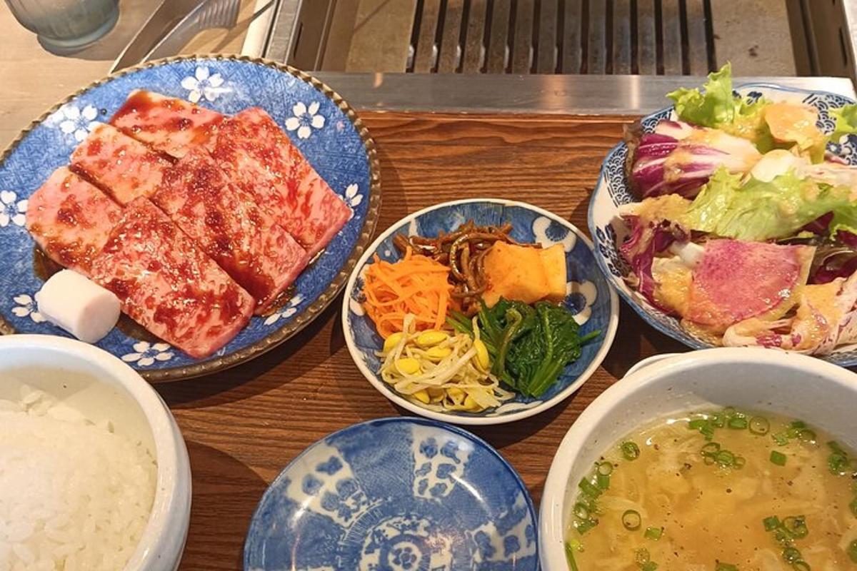 a table with plates of food and bowls of soup