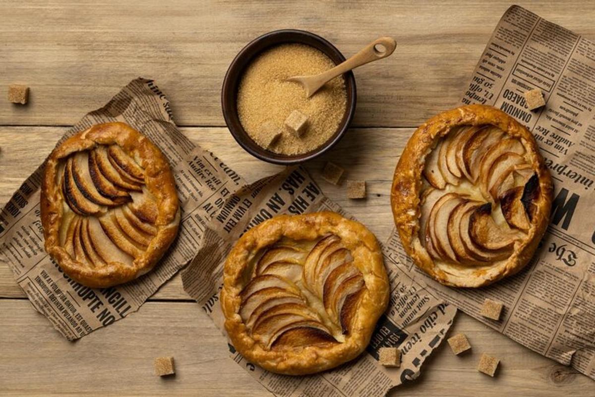 three pies on a table with a cup of coffee