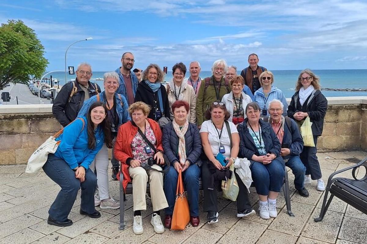 a group of people posing for a picture in front of the ocean