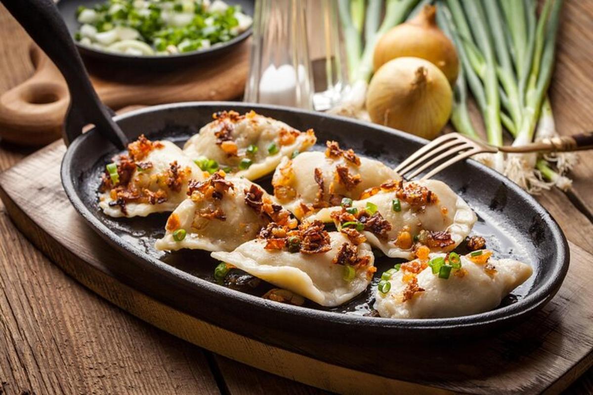 a plate of dumplings in a pan with a fork