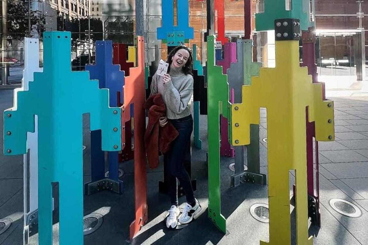 a woman is standing inside of a colorful structure