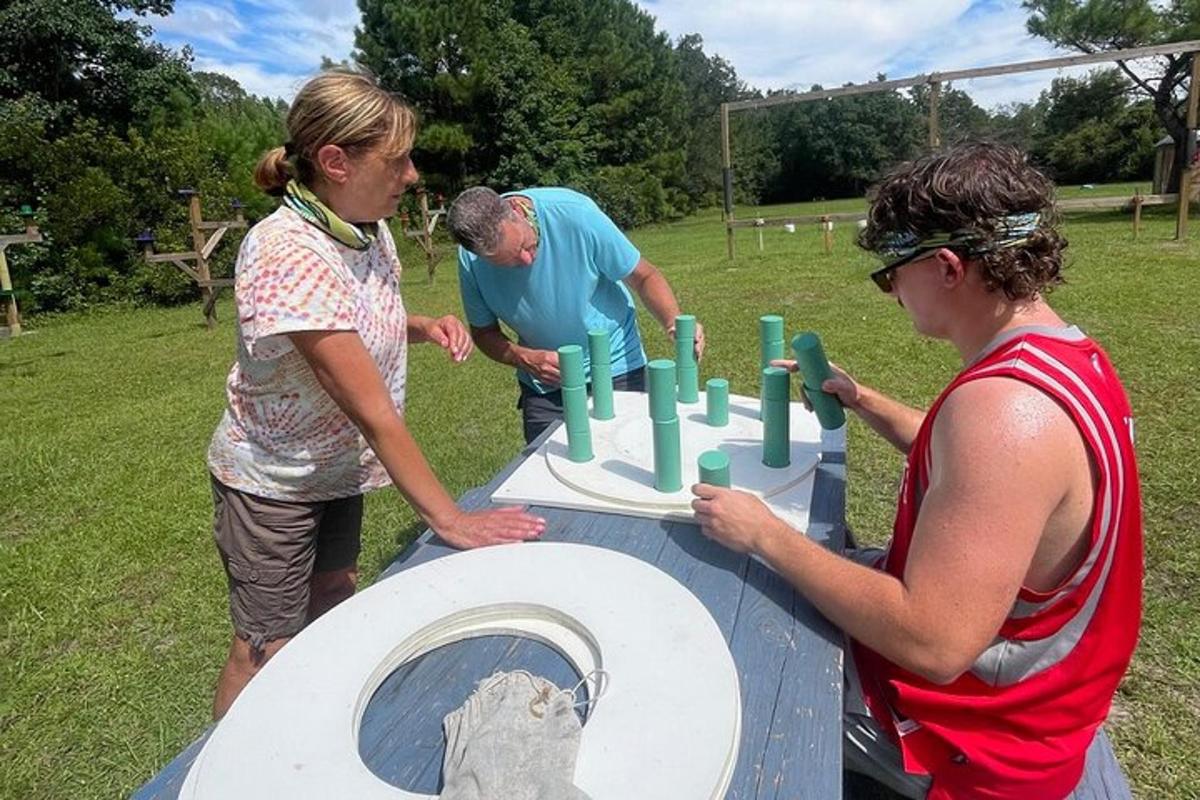 a group of people standing around a table with a cake