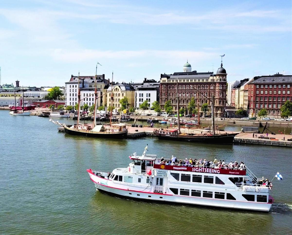 a boat in a river with buildings in the background
