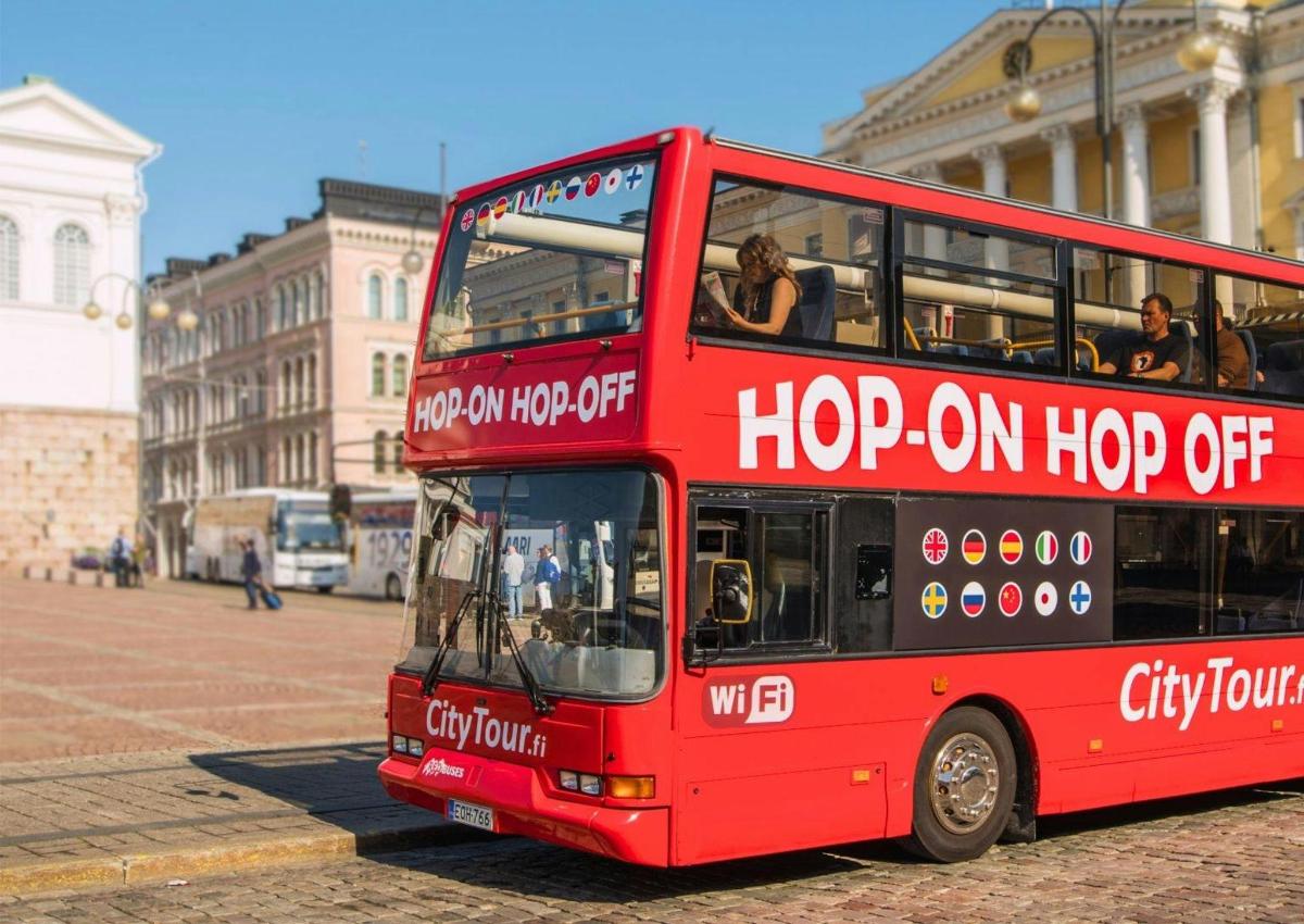 a red double decker bus parked on a street