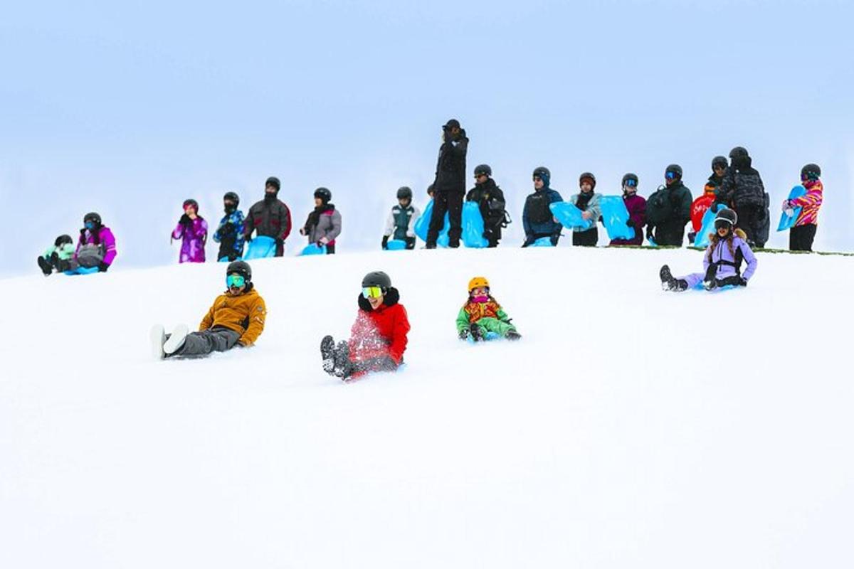 a group of people sitting in the snow