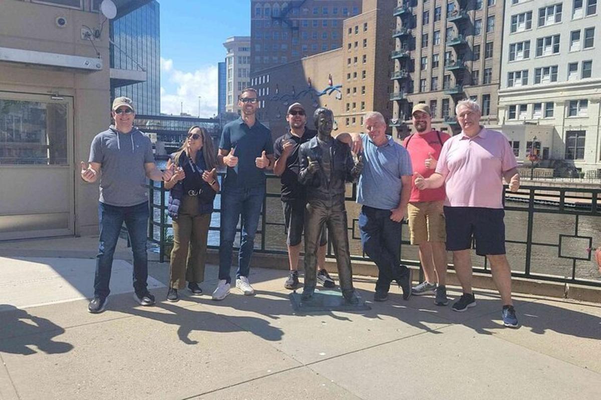 a group of people posing for a picture on a bridge