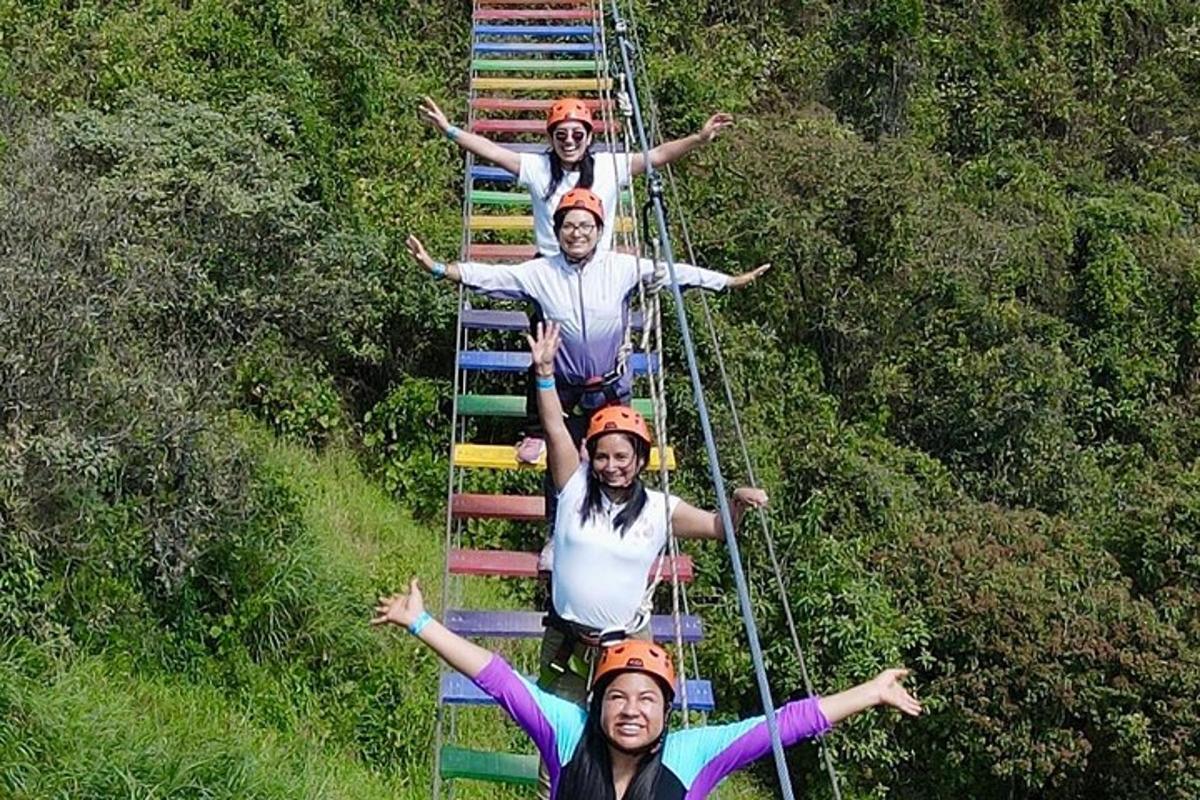 a group of people standing on a suspension bridge